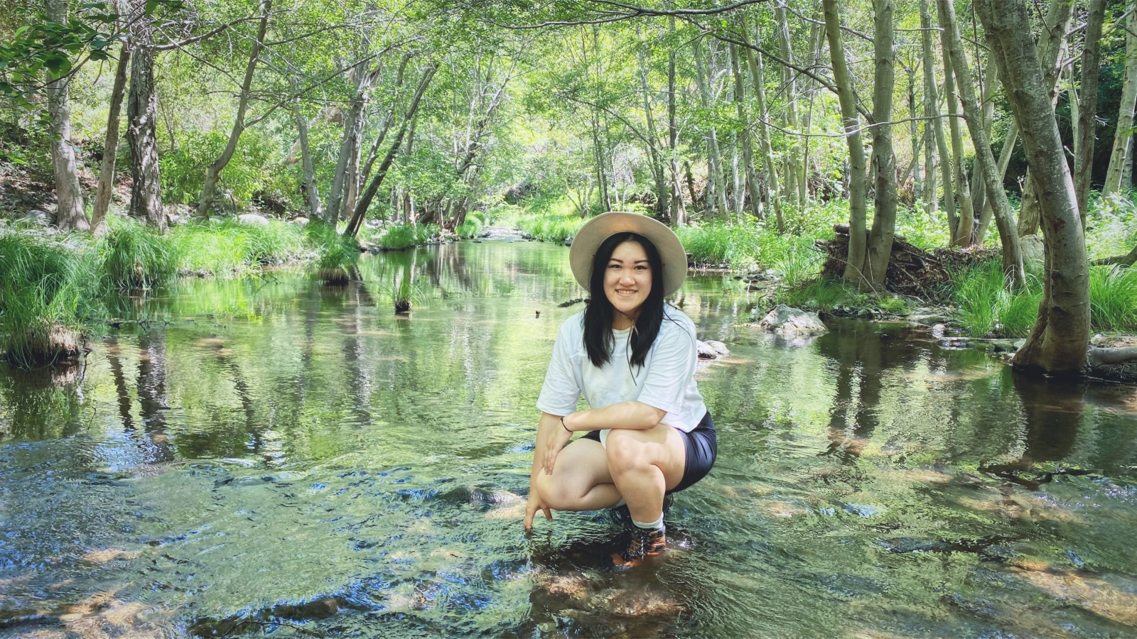 Anne Wong smiling during a hike in the wood