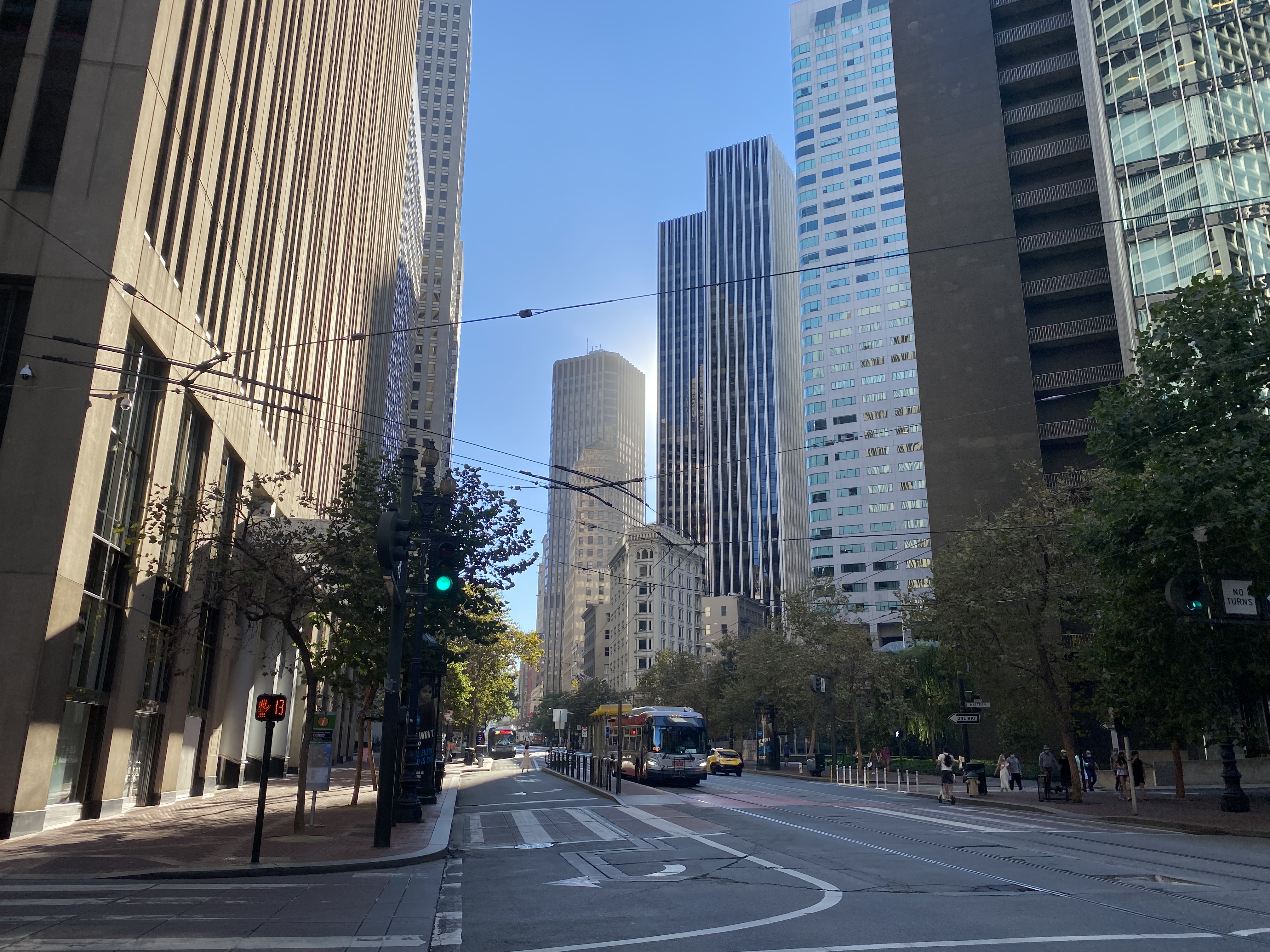 A street in downtown San Francisco with tall buildings on either side