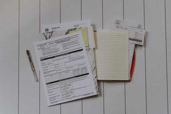 Stack of government forms and notepads for business filing