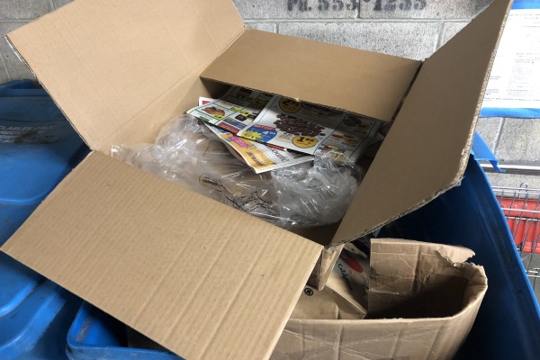 Blue recycling bin overflowing with recycled cardboard