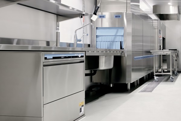 Industrial appliances for a commercial kitchen, including a dishwasher and dishwashing station
