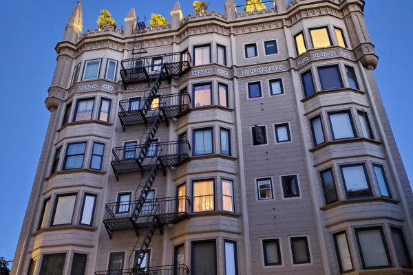 An apartment building at dusk in a residential San Francisco neighborhood