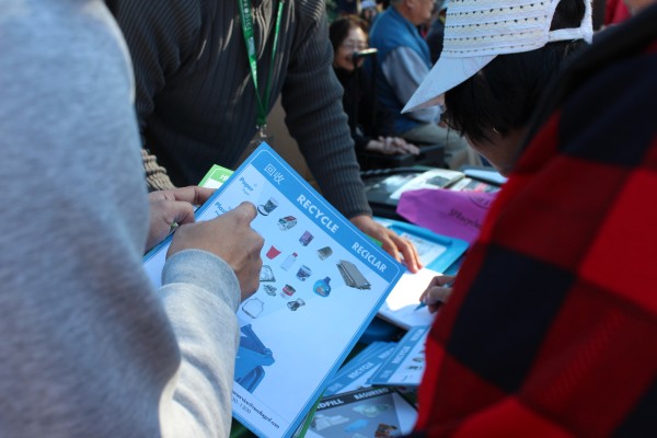 A tabling event with SFE staff showing SF residents the proper recycling items