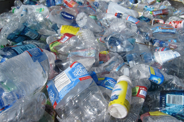 an assortment of plastic waste, mostly clear, squeezable water bottles