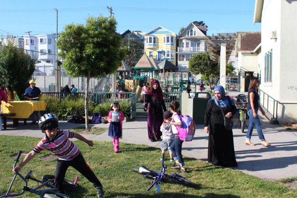 A family plays in a green space at a local park in San Francisco