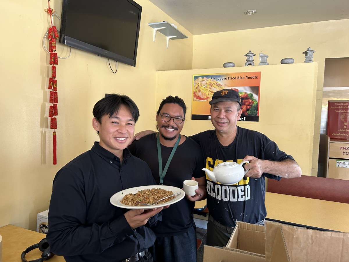 Three people are smiling for a picture. Two of the three are Department staff. The third, on the far right, is a SF restaurant owner holding a reusable ceramic teacup