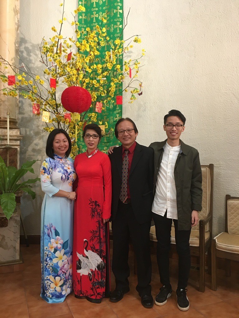 Minhthu and her family smiling near Lunar New Year decorations