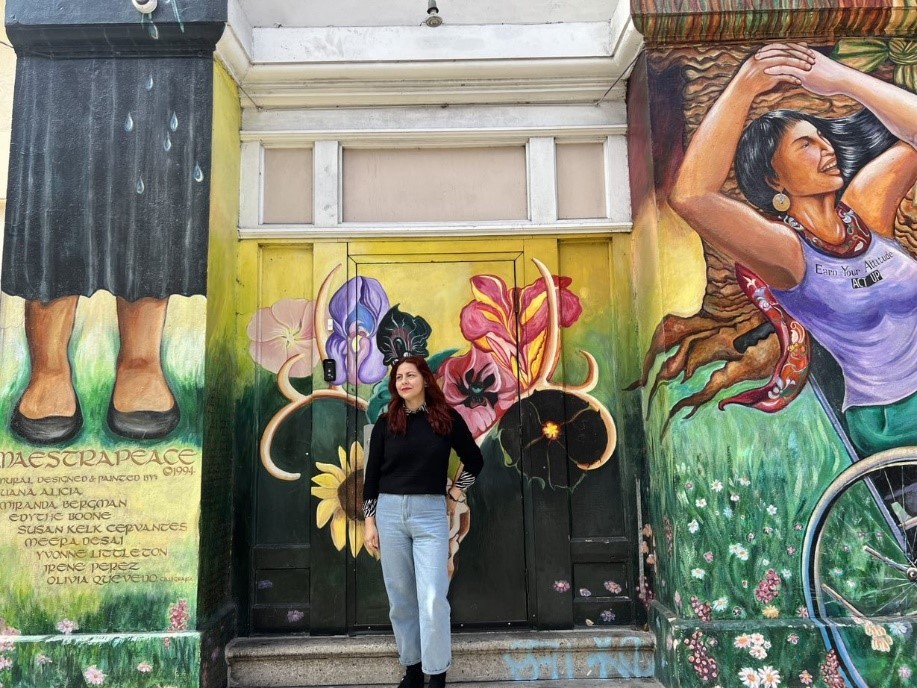 Maria A. smiling in front of Women's Building