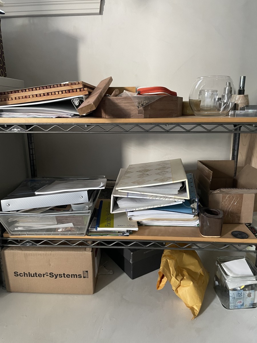 A stack of folders and boxes in a home closet