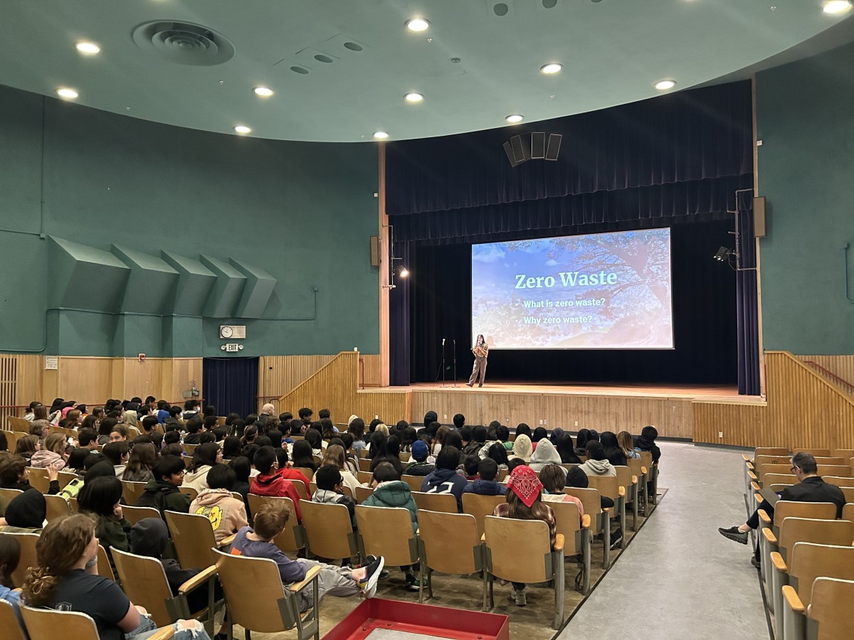Students sit in a large auditorium to hear a presentation from SFE staff on Zero Waste