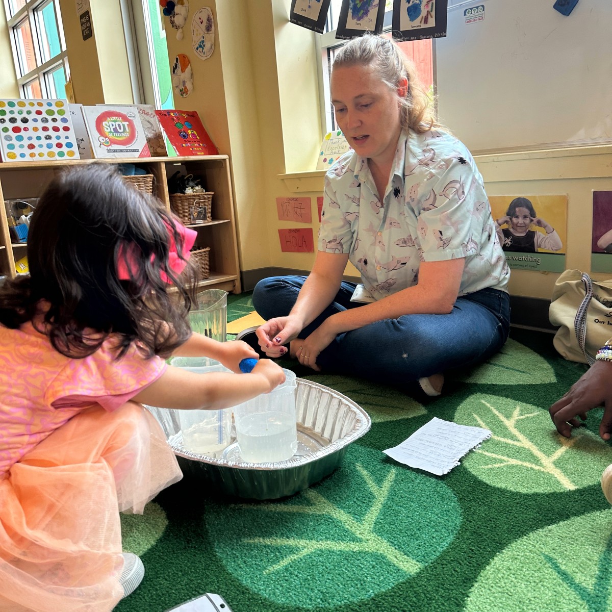 An environmental educator teaching young students about climate action through a hands-on activity.