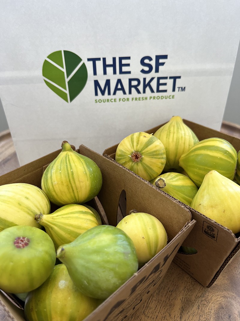 Figs in produce containers with a bag that says The SF Market behind