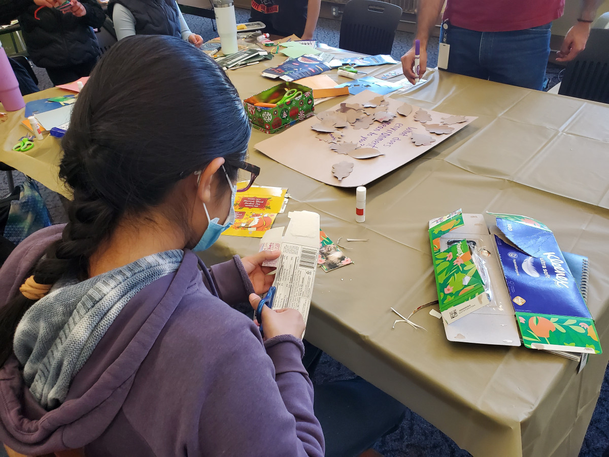 Girl cutting materials for reusable bookmarks