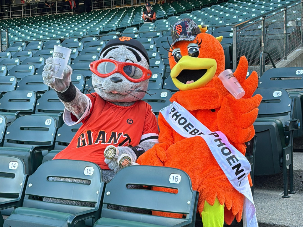 The SF Giants’ Lou Seal and SF Environment’s Phoebe the Phoenix, celebrating Oracle Arena’s shift to reusable cups to reduce plastic pollution in San Francisco.