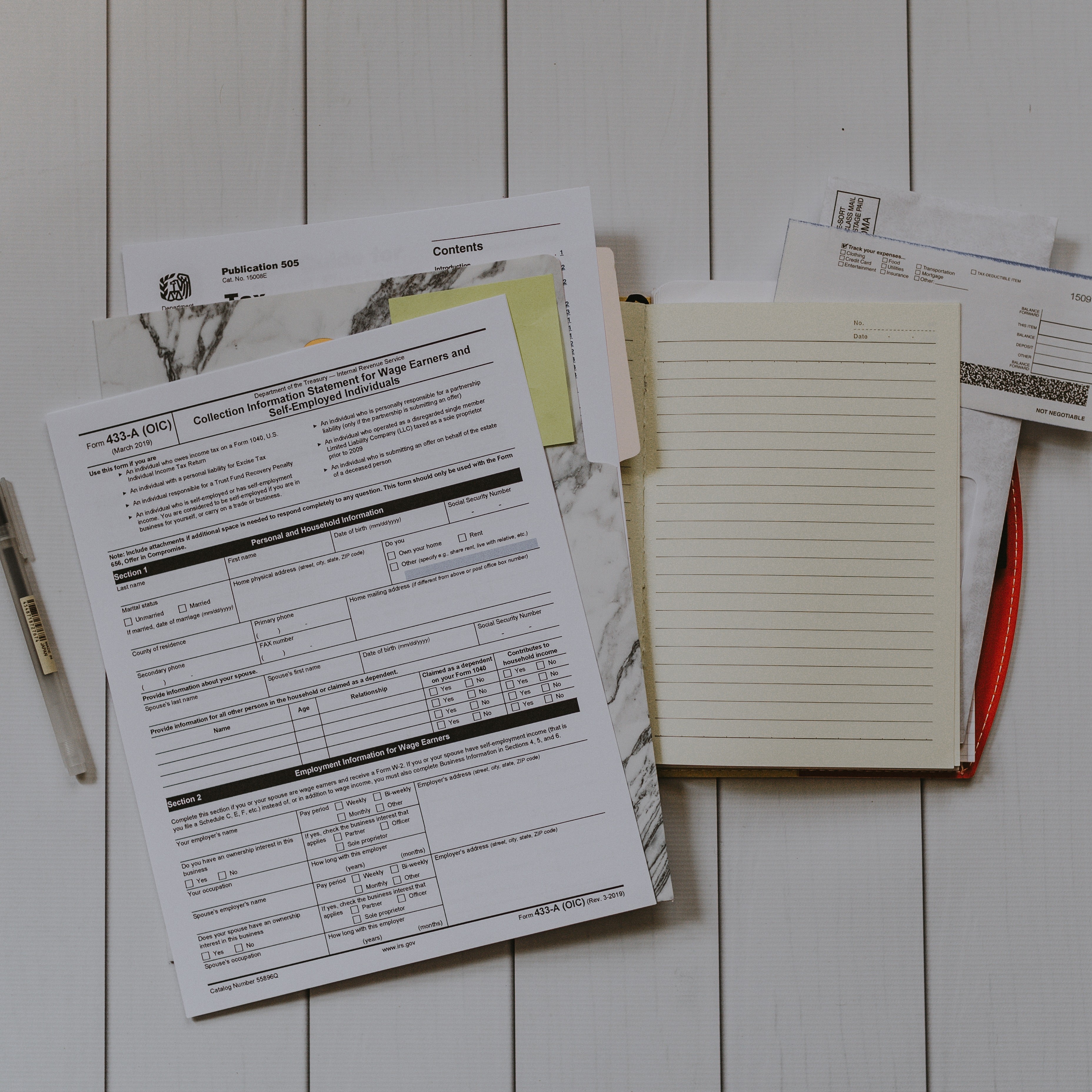 Stack of government forms and notepads for business filing