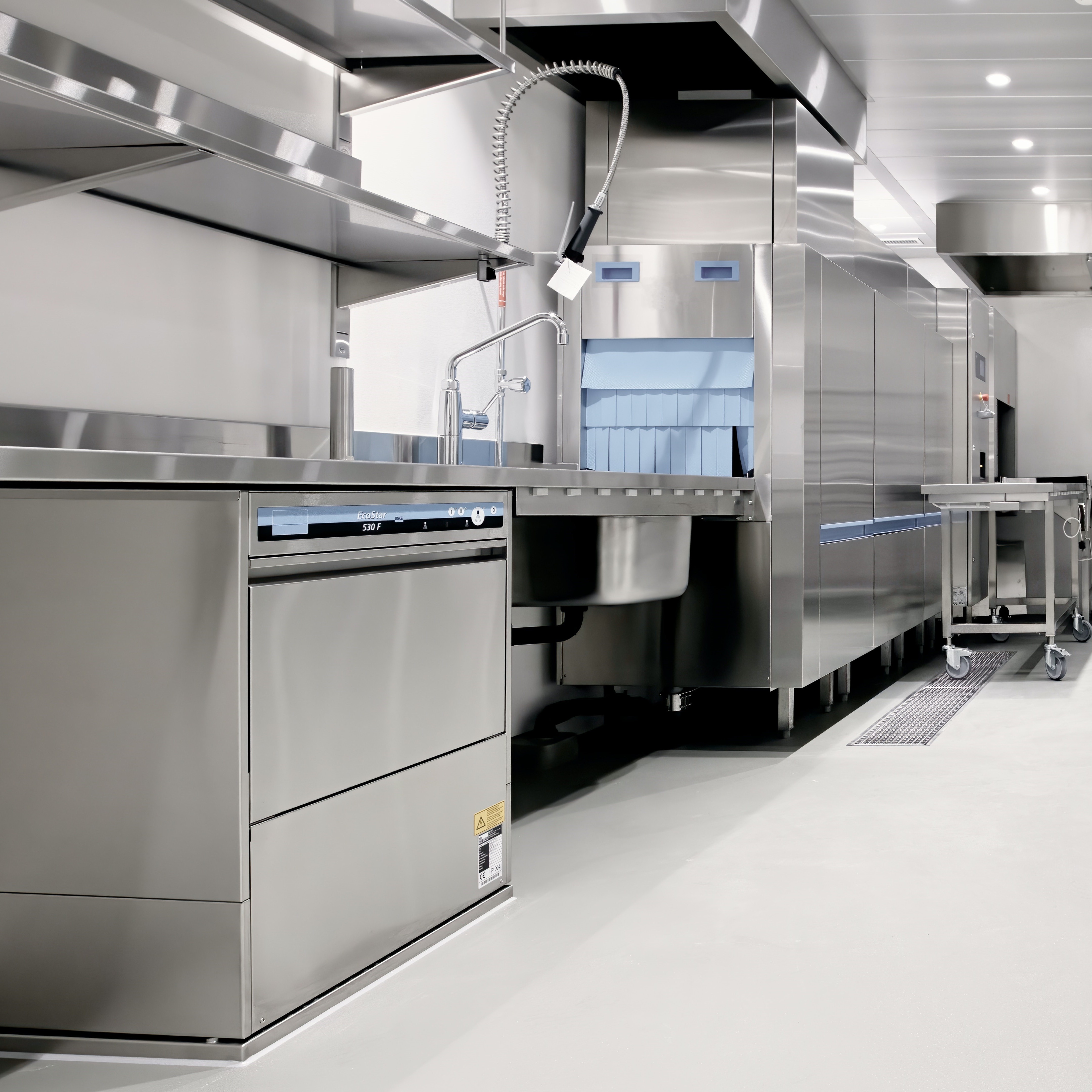 Industrial appliances for a commercial kitchen, including a dishwasher and dishwashing station