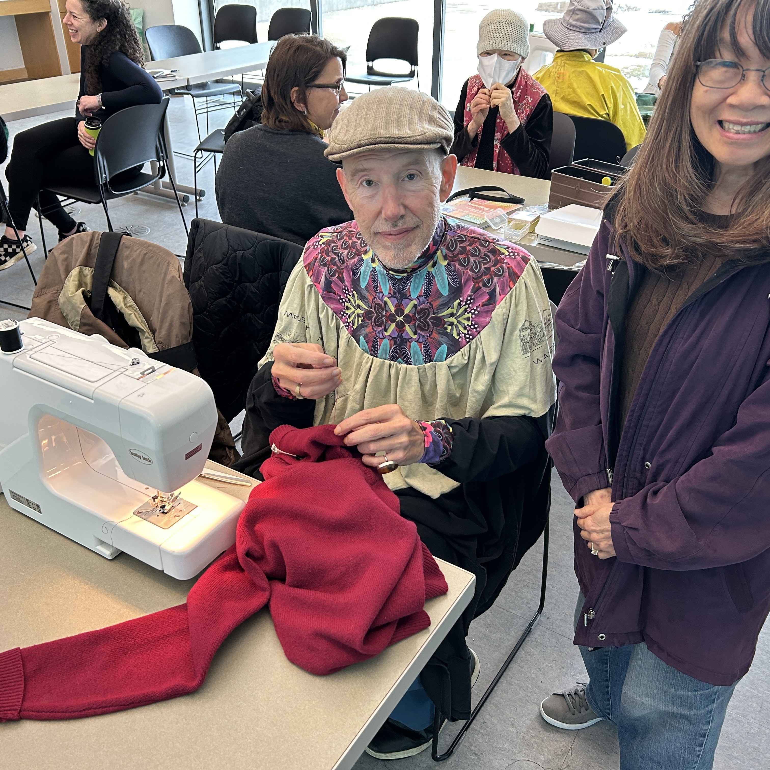 Sewing machine and seamstress at a table