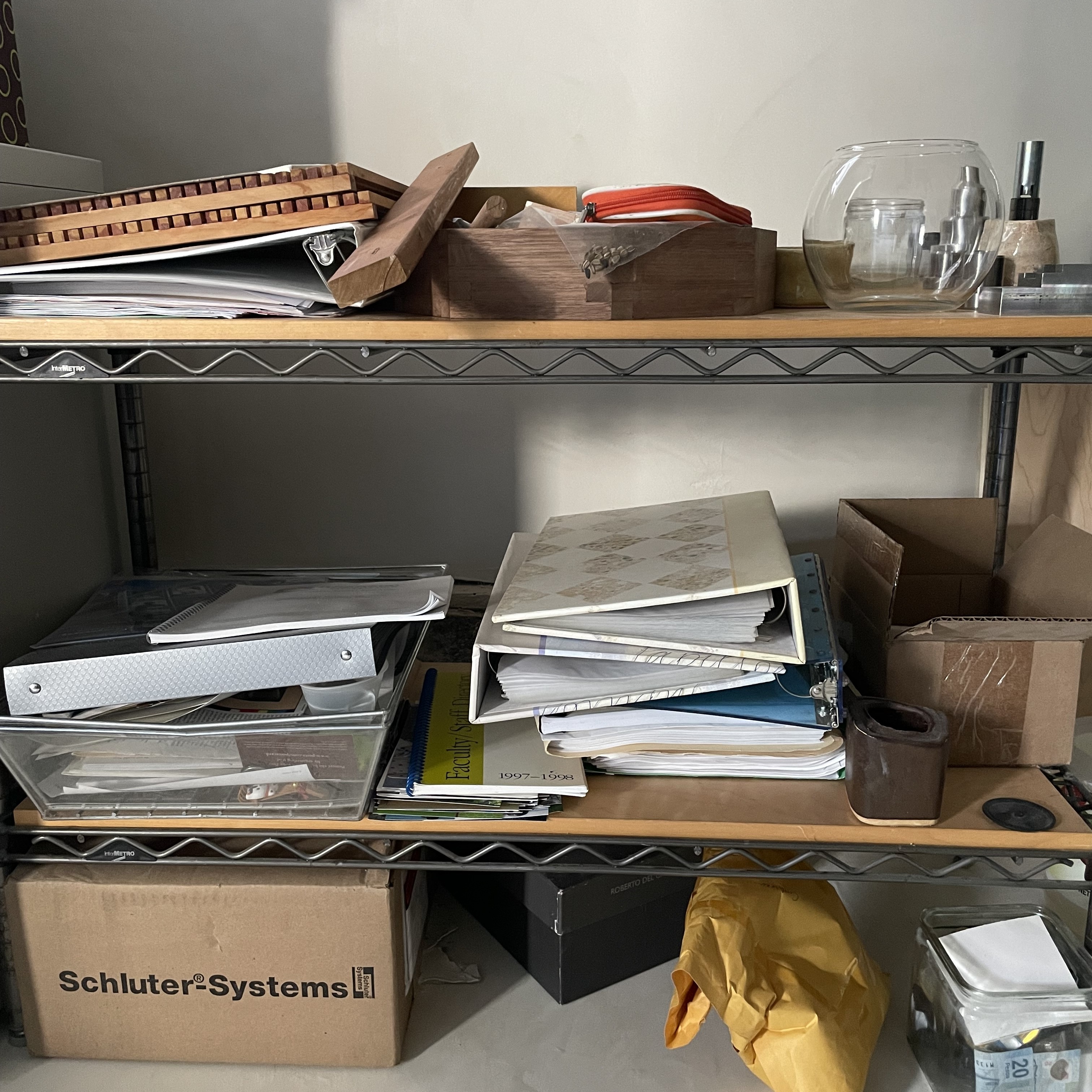 A stack of folders and boxes in a home closet