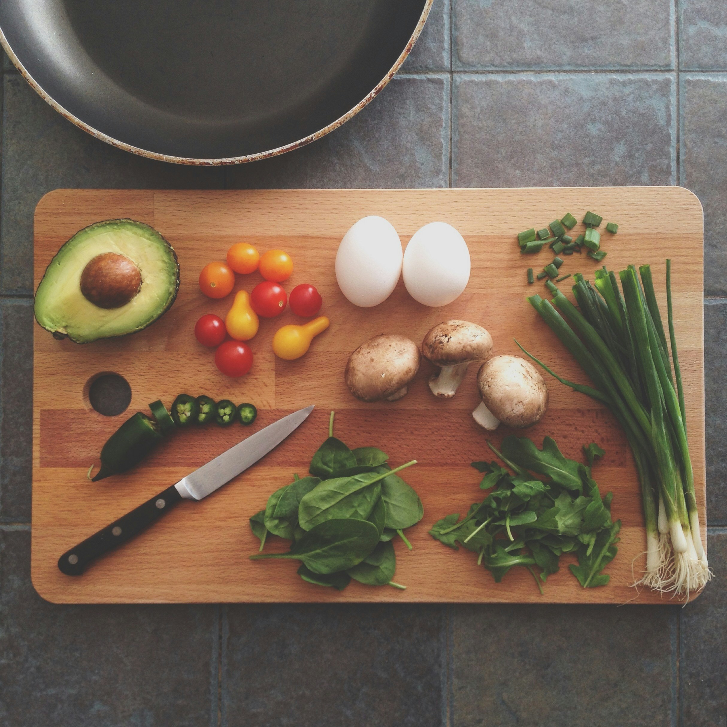 An assortment of vegetables on a wooden cutting board