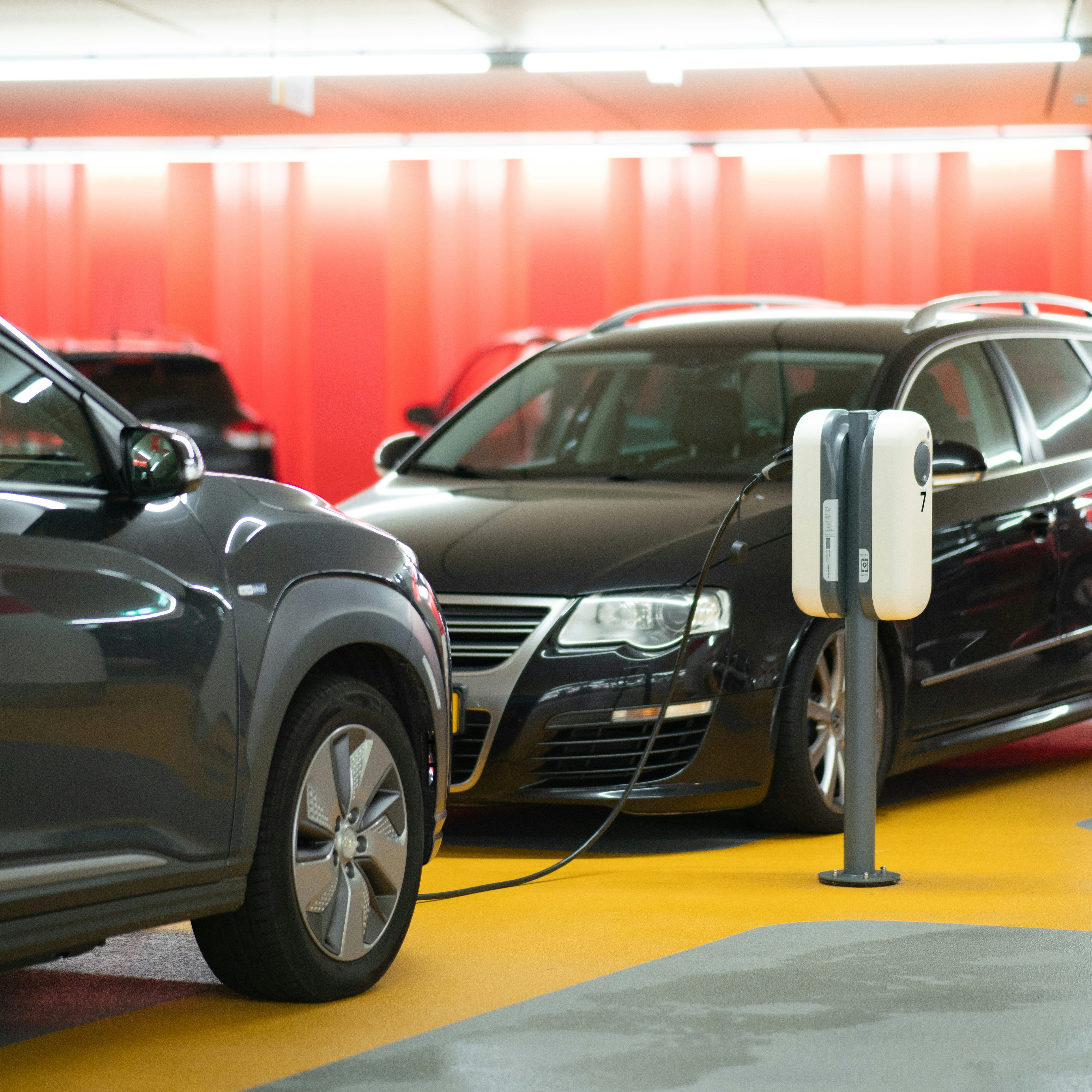 black sedans charge in a commercial garage