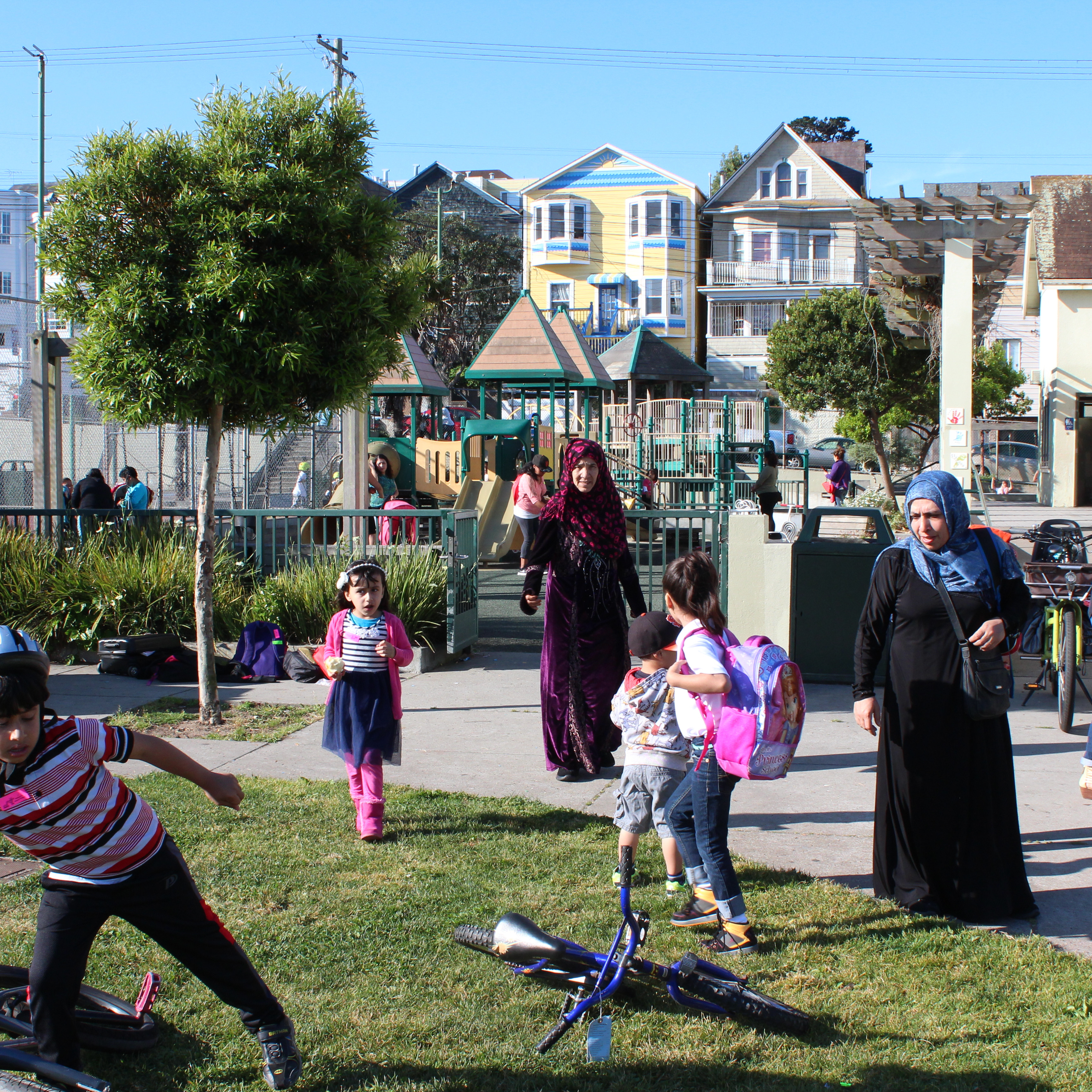 A family plays in a green space at a local park in San Francisco